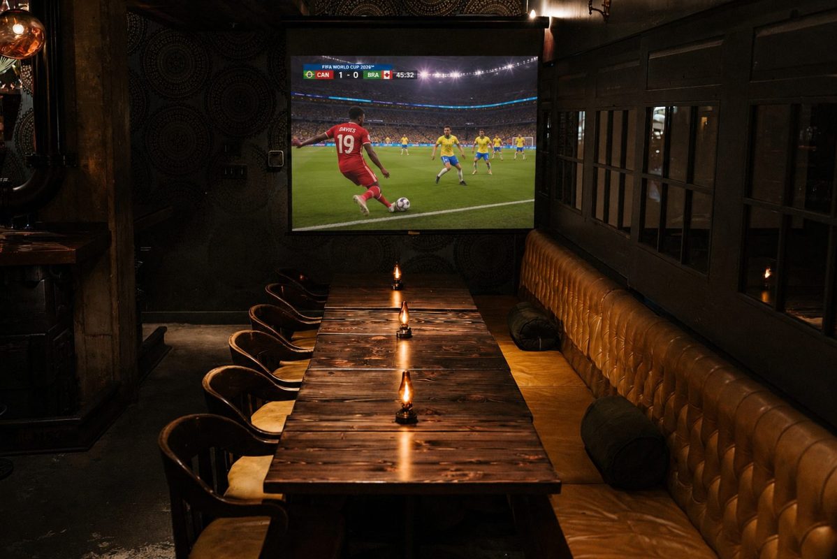 Private FIFA World Cup viewing room in Vancouver with projector screen, group seating, and upscale match-day atmosphere near BC Place