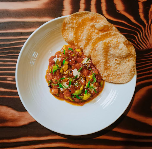 Sockeye salmon tartare served at The Parlour Toronto with avocado, crispy wontons, and elevated share plates on King West