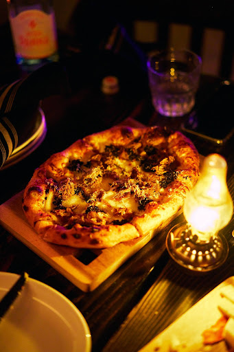I’m a Funghi pizza at The Parlour Toronto featuring mushroom, prosciutto, and cream on a wood-fired crust